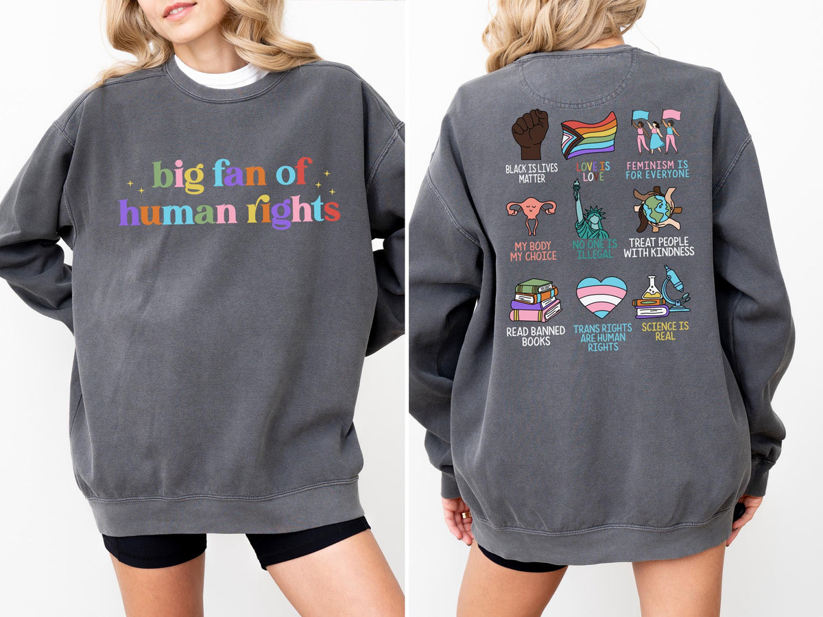 May include: A charcoal gray sweatshirt with the text "big fan of human rights" in colorful letters on the front. The back features various graphic illustrations and phrases, including "Black Lives Matter" and "Trans Rights are Human Rights."