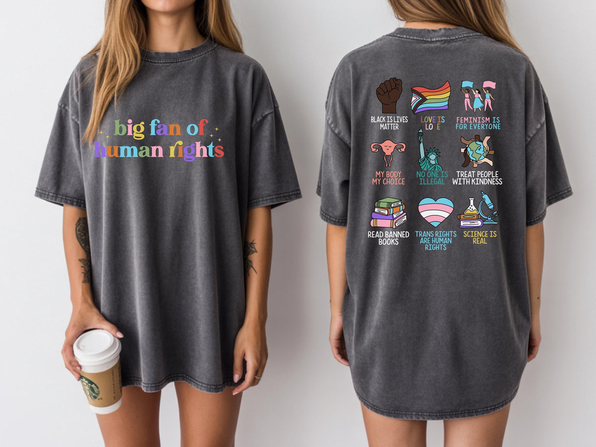 May include: Dark gray t-shirt with the text "big fan of human rights" in rainbow colors on the front. The back features various graphic icons and phrases, including "Black Lives Matter" and "Trans Rights are Human Rights."