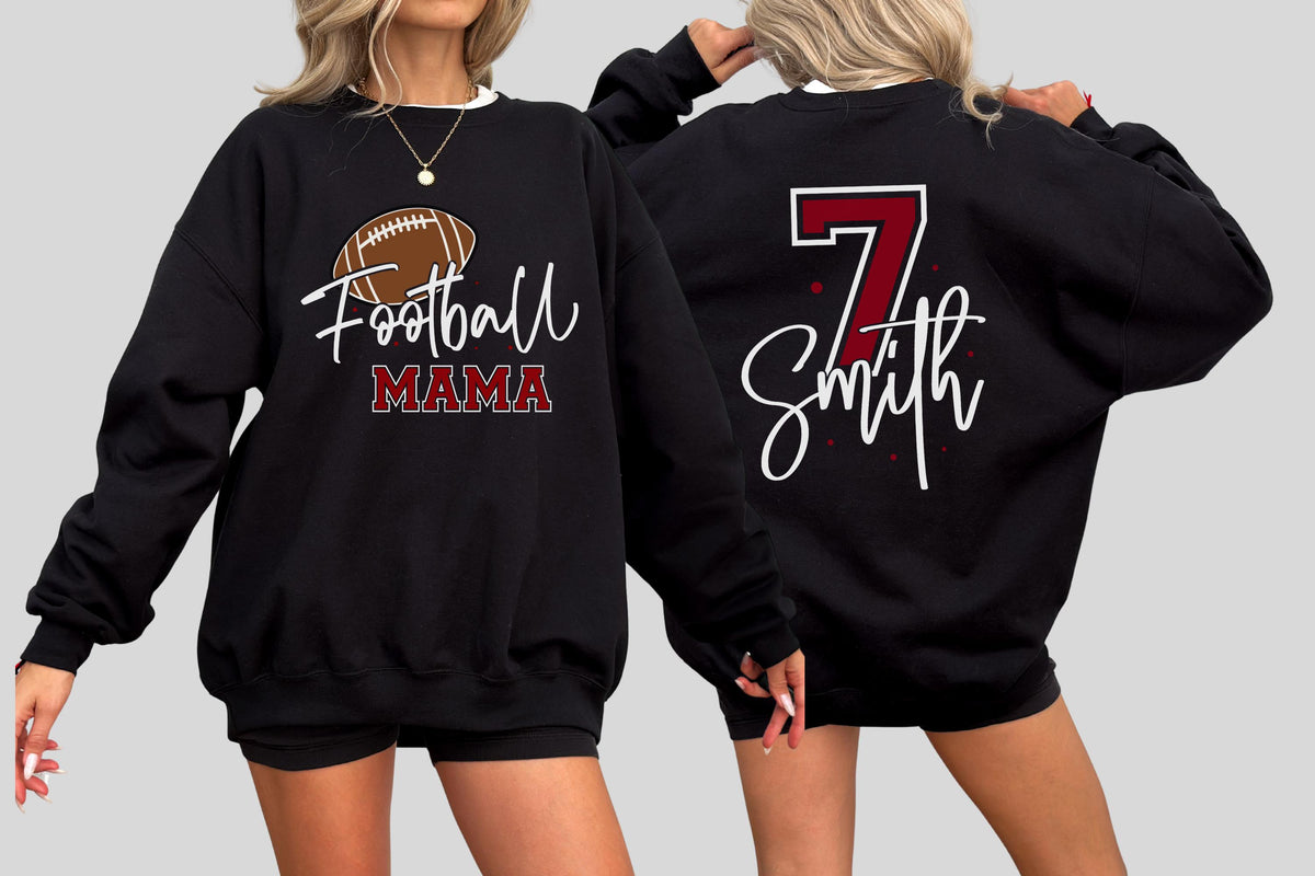 May include: A black crewneck sweatshirt featuring a graphic on the front with a brown football and the text Football MAMA in white and maroon. The back displays the number 7 in maroon with a white outline and the name Smith in white script.