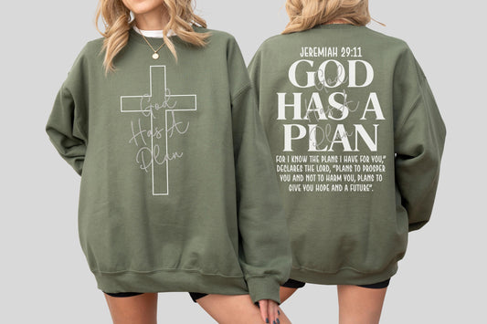 May include: Olive green sweatshirt with a white cross graphic and the text "God Has A Plan". The back of the sweatshirt features the text "Jeremiah 29:11 GOD HAS A PLAN" and a Bible verse. A casual, faith-based apparel item.