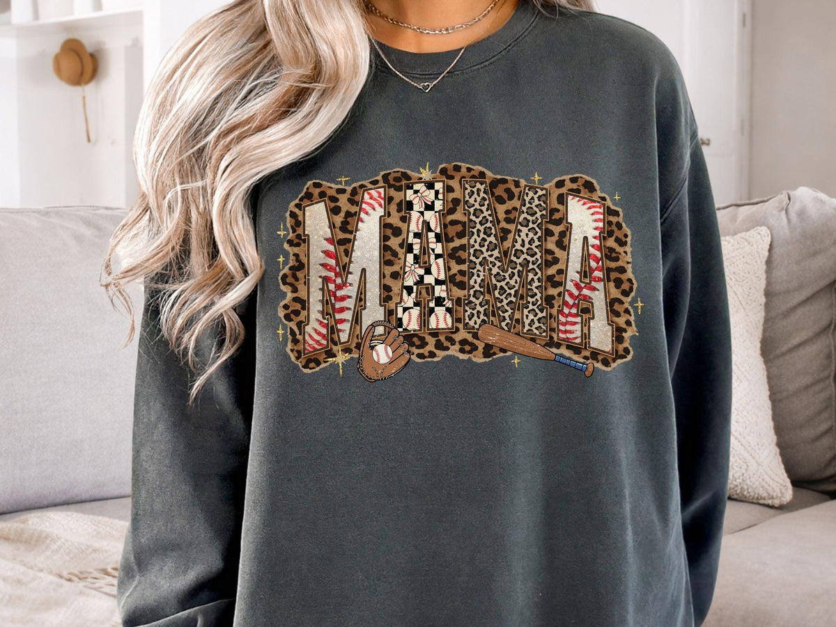 May include: Dark gray sweatshirt with the word "MAMA" in a baseball-themed design. The letters feature baseball stitching, leopard print, and a baseball bat and glove. The sweatshirt is a comfortable, casual style.