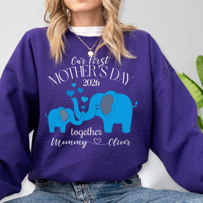 May include: A purple sweatshirt with a blue elephant design. The text "Our First Mother's Day 2026" is above the elephants, with "together Mommy Oliver" below. The design includes blue hearts.