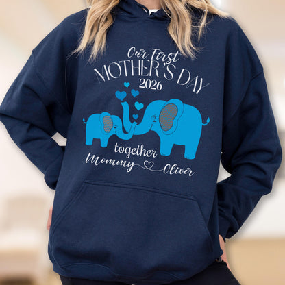 May include: Navy blue hoodie with a light blue elephant design. The design includes the text "Our First Mother's Day 2026" and "together Mommy ♡ Oliver". The hoodie has a front pocket and a drawstring hood.