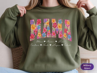 May include: Olive green sweatshirt with the word "MAMA" in a floral design. Below the word are names with hearts. The sweatshirt is a crew neck style.