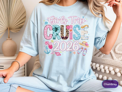 May include: Light blue t-shirt with the text "Girl's Trip CRUISE 2026" in colorful, playful lettering. The design includes tropical elements like a palm tree, cocktail, and sandals, perfect for a cruise vacation.