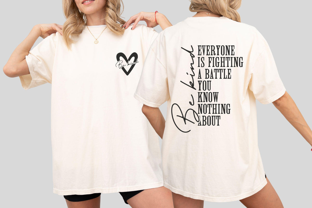 May include: Cream-colored t-shirt with a black heart graphic and the words "Be Kind" on the front and back. The back of the shirt features the text "Everyone is fighting a battle you know nothing about."