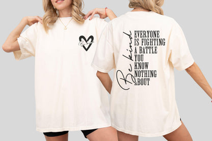 May include: Cream-colored t-shirt with a black heart graphic and the words "Be Kind" on the front and back. The back of the shirt features the text "Everyone is fighting a battle you know nothing about."