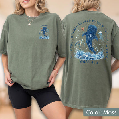 May include: Moss green t-shirt with a marine-themed graphic. The front features a whale shark illustration with the text "ISAIAH 43:2". The back displays a larger design with the text "WHEN YOU GO THROUGH DEEP WATERS, I WILL BE WITH YOU" and "ISAIAH 43:2".