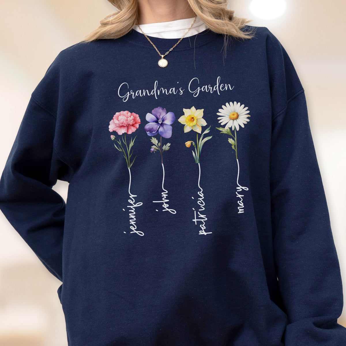 May include: Navy blue sweatshirt with the text "Grandma's Garden" and four colorful flower illustrations. Each flower has a name written below it: Jennifer, John, Patricia, and Mary.