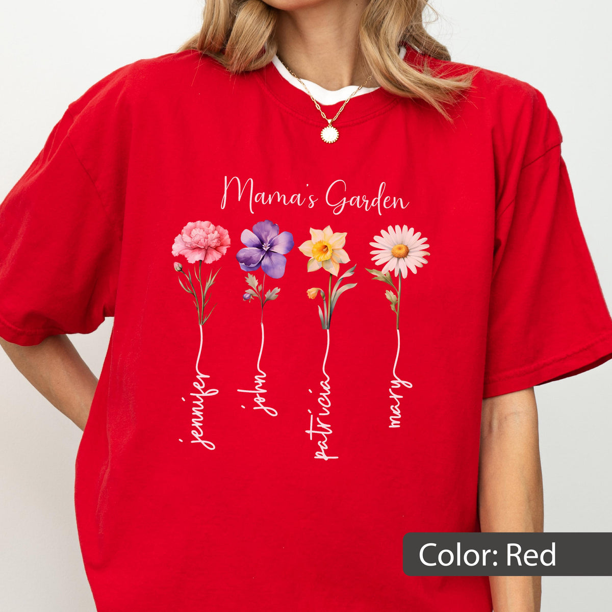 May include: Red t-shirt with the text "Mama's Garden" and floral illustrations. The shirt features four flowers with names: Jennifer, John, Patricia, and Mary. The shirt has a white collar.
