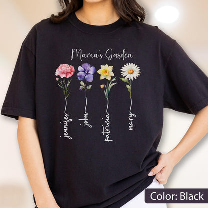 May include: Black t-shirt with the text "Mama's Garden" and four colorful flower illustrations. Each flower has a name written below it: Jennifer, John, Patricia, and Mary. The shirt's color is black.