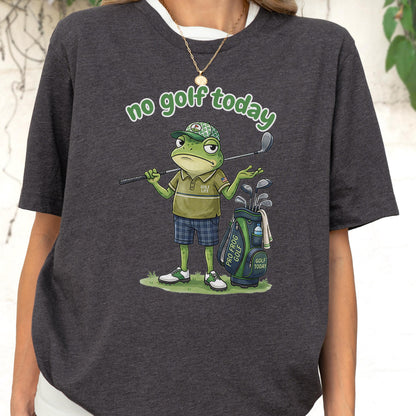 May include: Dark gray t-shirt featuring a cartoon frog with a golf club, golf bag, and the text "no golf today" in green. The frog is wearing a golf hat, polo shirt, and plaid shorts. The golf bag has the text "Pro Frog Golf" and "Golf Today".