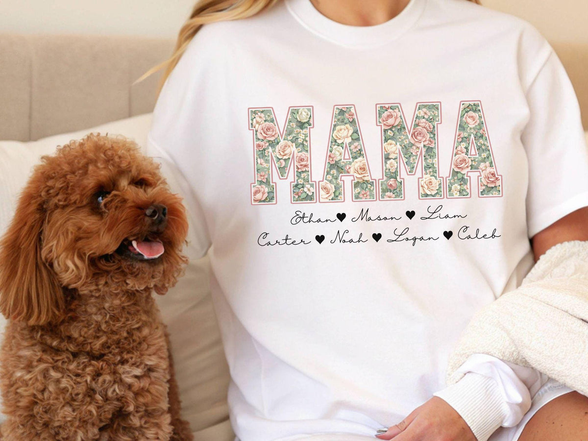 May include: White t-shirt with the word "MAMA" in a floral design. Below the word "MAMA" are the names Ethan, Mason, Liam, Carter, Noah, Logan, and Caleb. A brown poodle is in the image.