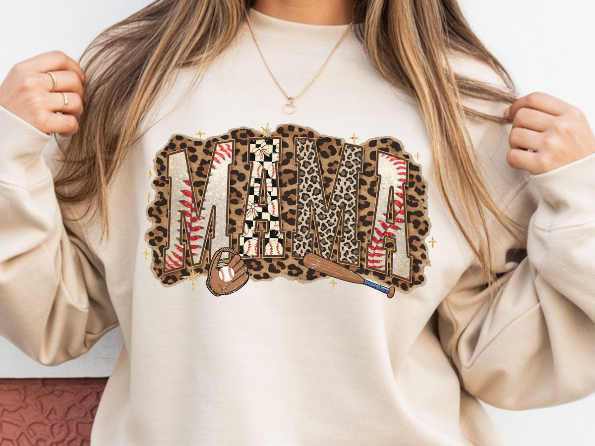 May include: A beige sweatshirt with the word "MAMA" in a baseball-themed design. The letters are a mix of leopard print, baseball stitching, and a checkered pattern. A baseball glove and bat are also featured.
