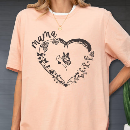 May include: A peach-colored t-shirt with a black heart-shaped design filled with butterflies and vines. The word "mama" is above the heart, and the names "Olivia, Noah, Sophia" are below.