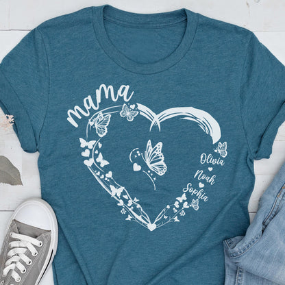 May include: Teal t-shirt with a white heart-shaped design. The heart is adorned with butterflies and the word "mama" at the top. Names "Olivia", "Noah", and "Sophia" are written inside the heart.