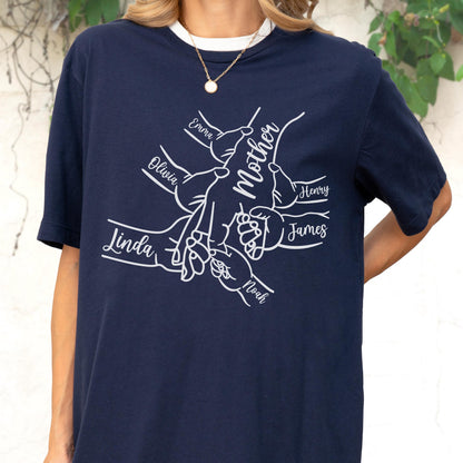 May include: Navy blue t-shirt with a white graphic of hands holding each other, with the word "Mother" in the center. Names "Emma", "Olivia", "Linda", "Noah", "Henry", and "James" are written around the hands.