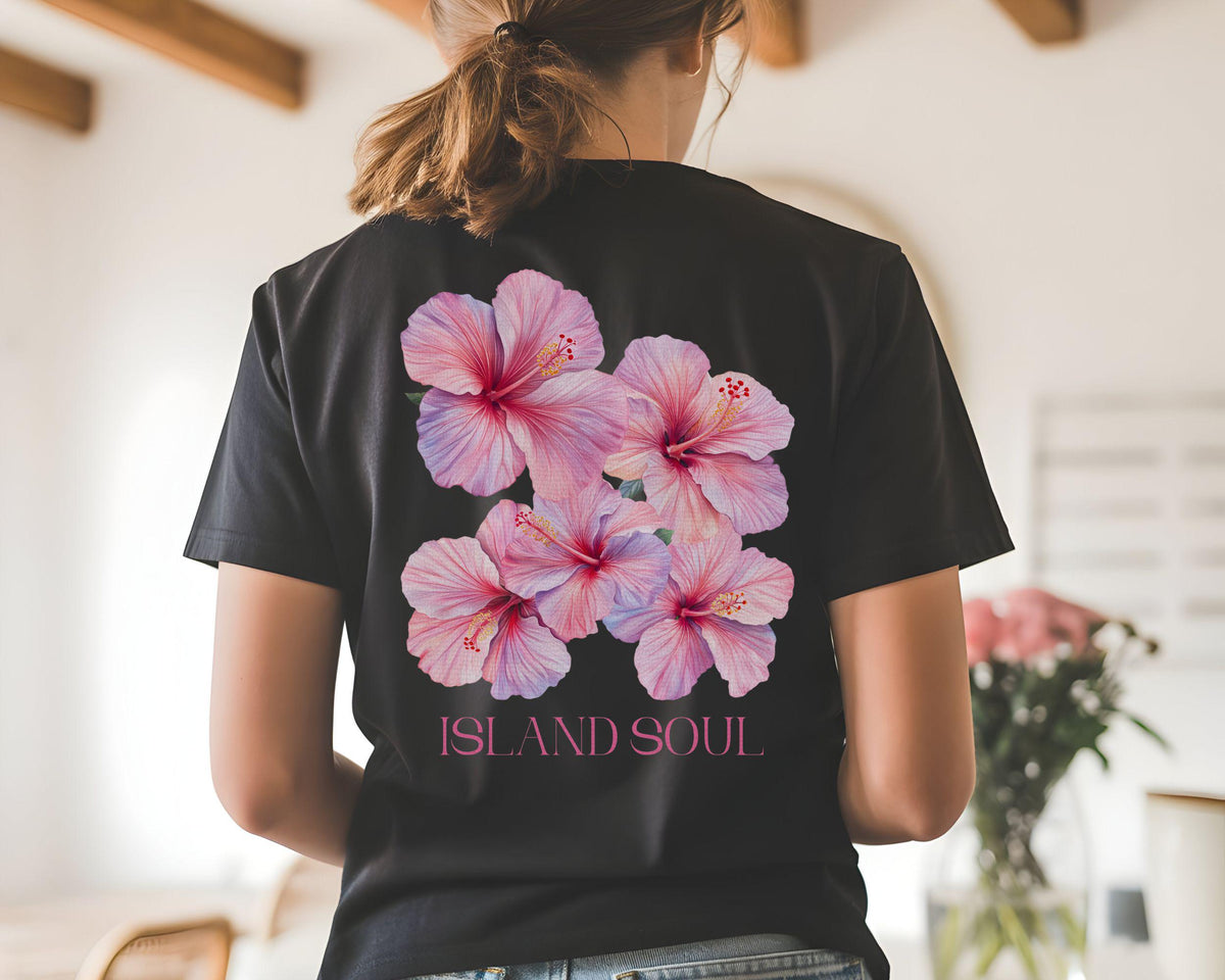 May include: Black t-shirt featuring a cluster of pink and purple hibiscus flowers. The text "ISLAND SOUL" is printed below the floral design. The shirt has short sleeves and a crew neck.