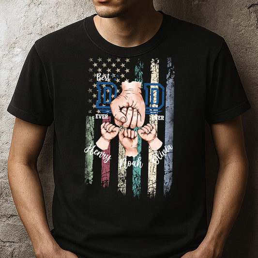 May include: Black t-shirt with a distressed American flag design. The flag has the words "Best Dad Ever" and "Dad" in blue letters. The flag is surrounded by three hands holding each other, with the names "Henry", "Noah", and "Olivia" written below.