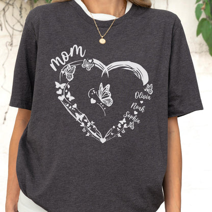 May include: Dark gray t-shirt featuring a white heart design filled with butterflies and the word "Mom" at the top. The names "Olivia", "Noah", and "Sophia" are written inside the heart.