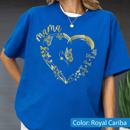 May include: Royal Cariba blue t-shirt with a gold heart design. The heart is adorned with butterflies and the word "mama". Names Olivia, Noah, and Sophia are also featured. The shirt is a solid color with a white crew neck collar.