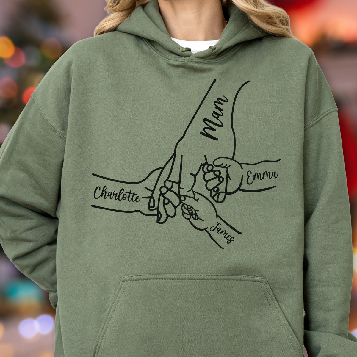 May include: An olive green hoodie with a black graphic of hands holding each other. The word "Mam" is written on the largest hand, with the names "Charlotte", "Emma", and "James" on the other hands.