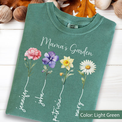 May include: Light green t-shirt with the text "Mama's Garden" and floral illustrations. The shirt features a pink carnation, purple pansy, yellow daffodil, and white daisy. Names are written below each flower: Jennifer, John, Patricia, and Mary.