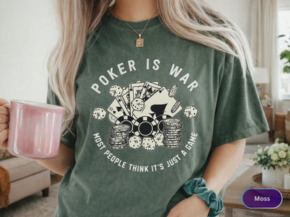May include: Moss green t-shirt with the text "Poker is War" and a graphic of playing cards, dice, and poker chips. The text "Most people think it's just a game" is also printed on the shirt.