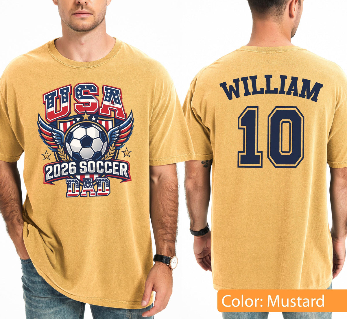 May include: Mustard-colored t-shirt with a soccer-themed graphic. The front features "USA" in red and blue, a soccer ball, wings, and "2026 SOCCER DAD." The back displays "WILLIAM" above the number "10" in navy blue.