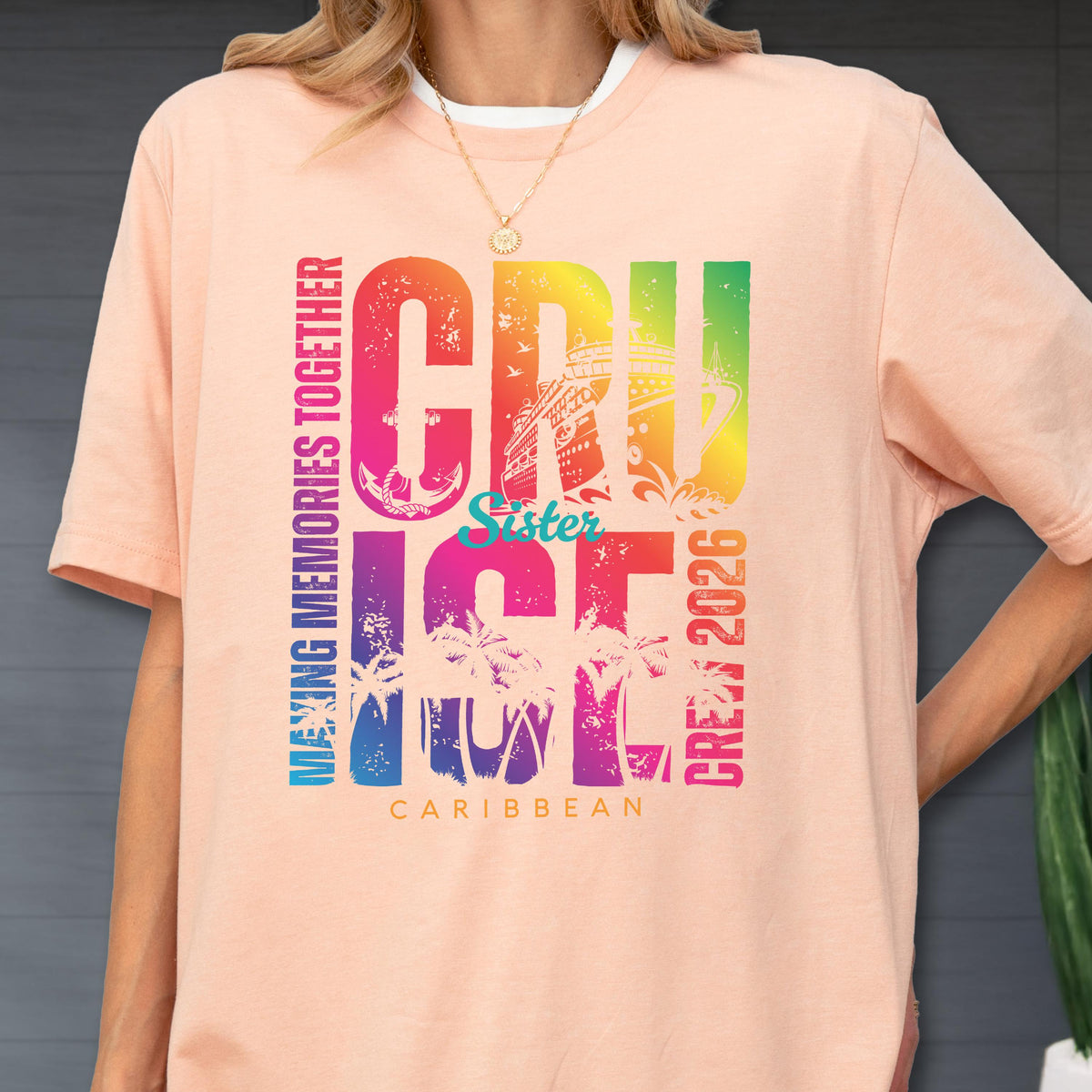 May include: A peach-colored t-shirt with a white collar features a colorful graphic that reads "CRUISE" with a cruise ship illustration, "Sister", "ICE", "CREW 2026", and "CARIBBEAN". The words "MAKING MEMORIES TOGETHER" are printed vertically.