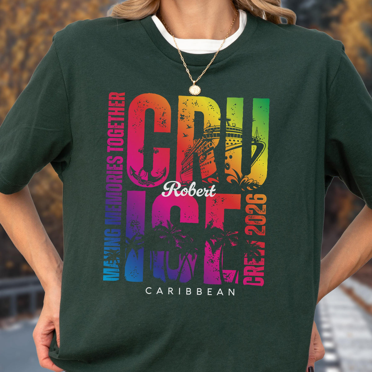 May include: Dark green t-shirt with a colorful cruise ship graphic. The design includes the word "CRUISE" in rainbow colors, the name "Robert", and the text "Caribbean Crew 2026". The shirt also features palm trees and the phrase "Making Memories Together".