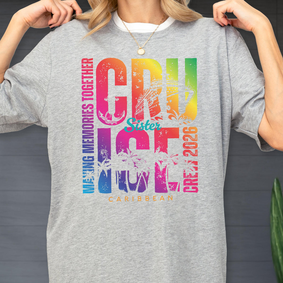 May include: A gray crew neck t-shirt with a colorful graphic that says "CRUISE" in large letters, with "MAKING MEMORIES TOGETHER" and "CREW 2026" vertically on the sides. The word "Sister" is in the middle.