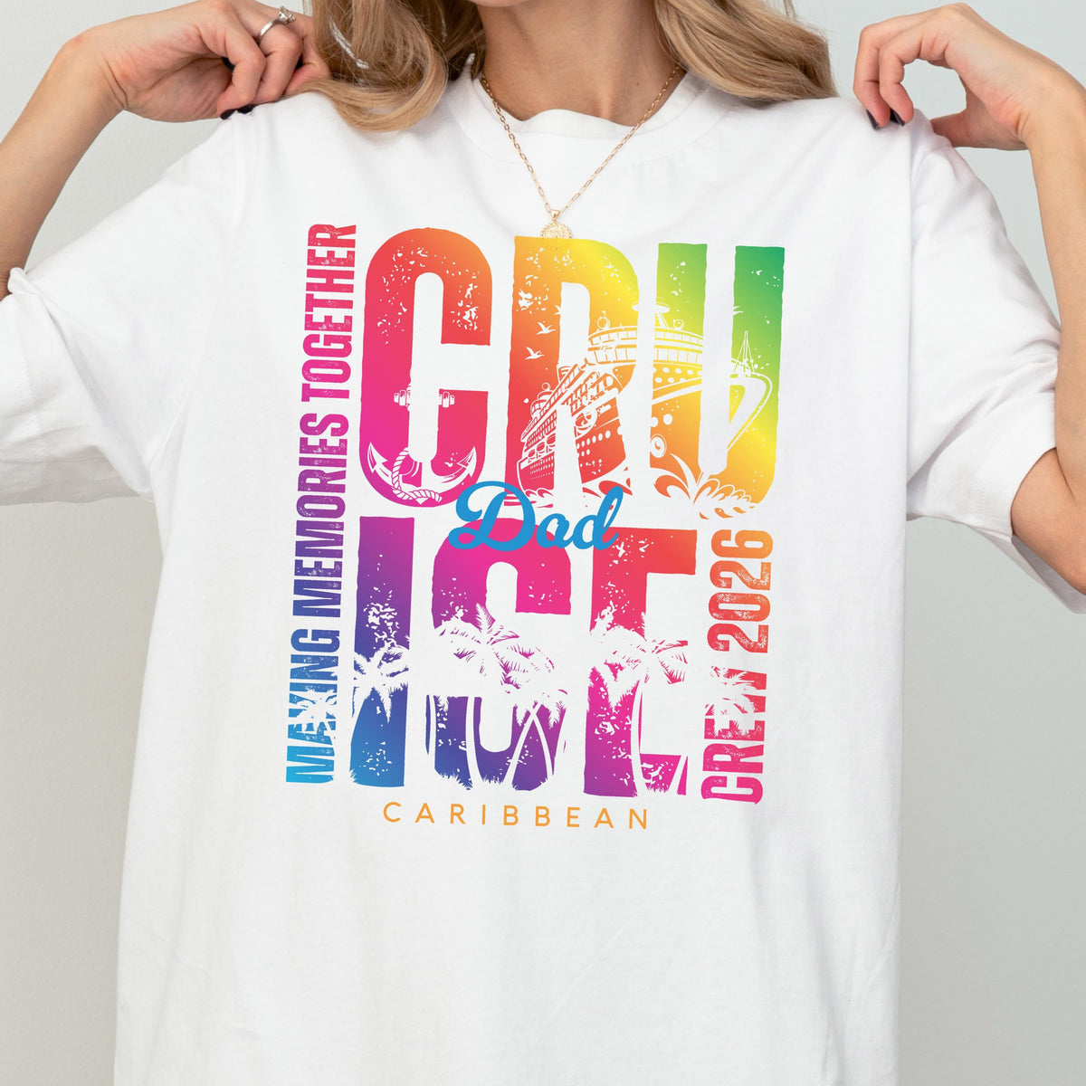 May include: White t-shirt with a colorful graphic that reads "CRUISE Dad ICE CREW 2026" in a rainbow gradient. The design includes an anchor, a cruise ship, and palm trees, with the word "CARIBBEAN" at the bottom. The text "MAKING MEMORIES TOGETHER" is printed vertically on the left side.