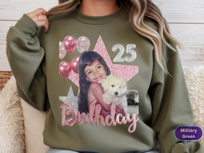 May include: A military green crewneck sweatshirt featuring a graphic print of a young child holding a white puppy. The design includes pink balloons, a large pink glitter star, a silver star, the number 25, and the word Birthday in pink script.