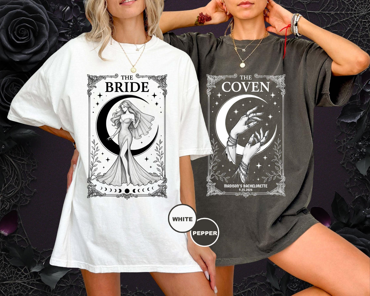 May include: A white t-shirt featuring a black graphic of a bride in a gown under a crescent moon with the text THE BRIDE, and a charcoal gray t-shirt featuring a black graphic of hands under a crescent moon with the text THE COVEN.