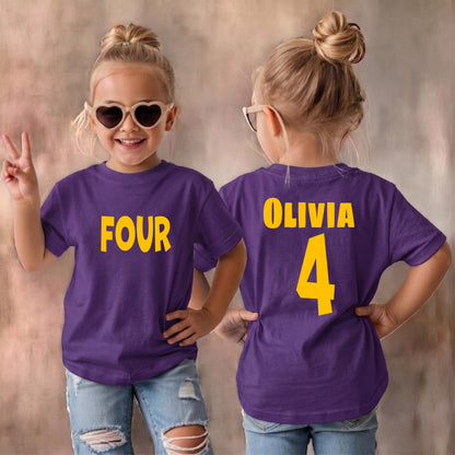 May include: A purple short-sleeved t-shirt featuring the word FOUR in yellow on the front and the name OLIVIA with the number 4 in yellow on the back. The shirt is paired with light blue distressed denim jeans and heart-shaped sunglasses.