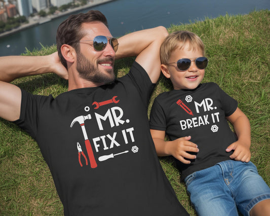 May include: Two black t-shirts with white and red graphic prints. The larger shirt features a hammer, wrench, pliers, screwdriver, and the text MR. FIX IT. The smaller shirt features a pencil and the text MR. BREAK IT with nut icons.