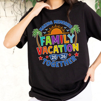 May include: A black t-shirt featuring a colorful graphic with the text "MAKING MEMORIES FAMILY VACATION TOGETHER 20 26". The design includes a yellow sun, green palm trees, blue sunglasses, and red stars, all arranged in a circular pattern.