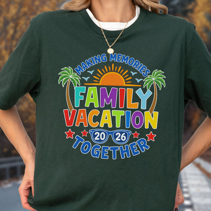 May include: A dark green short-sleeve t-shirt featuring a colorful graphic with the text "MAKING MEMORIES FAMILY VACATION TOGETHER 20 26". The design includes a sun, two palm trees, and blue sunglasses, all rendered in vibrant shades of red, orange, yellow, green, and blue.