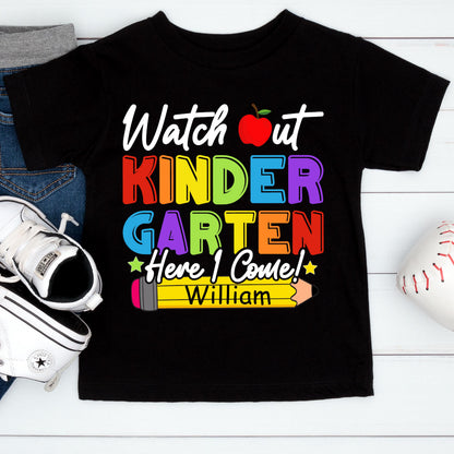 May include: A black short-sleeve t-shirt featuring the text "Watch out KINDERGARTEN Here I Come!" in colorful letters, a red apple graphic, a yellow pencil graphic with the name "William" printed on it, and two small stars.