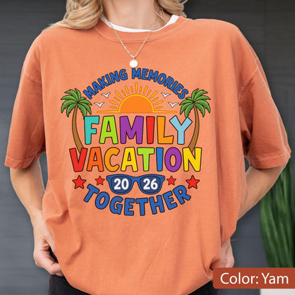 May include: A yam-colored t-shirt featuring a graphic print with the text "MAKING MEMORIES FAMILY VACATION TOGETHER 20 26". The design includes a yellow sun, two green palm trees, and blue sunglasses. The text is in various colors including blue, green, yellow, and red.