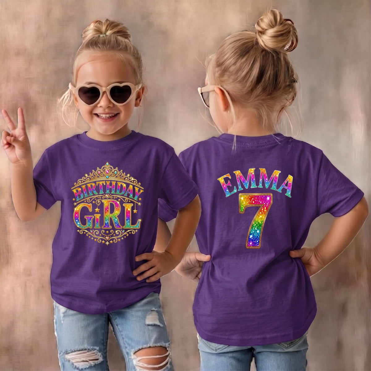 May include: A purple short-sleeved t-shirt featuring a front graphic of a gold crown with the text Birthday Girl in rainbow colors. The back of the shirt displays the name Emma in rainbow letters above a large rainbow-colored number 7.