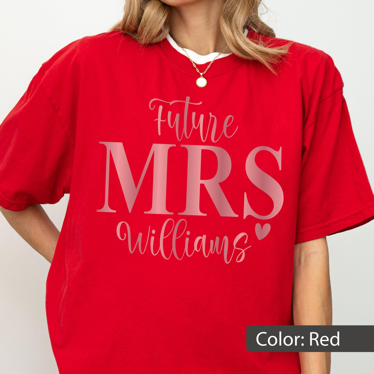 May include: A bright red short-sleeved t-shirt featuring the text Future MRS Williams in a combination of script and bold serif fonts. A small heart icon is positioned to the right of the name. The shirt has a crew neckline and a relaxed fit.