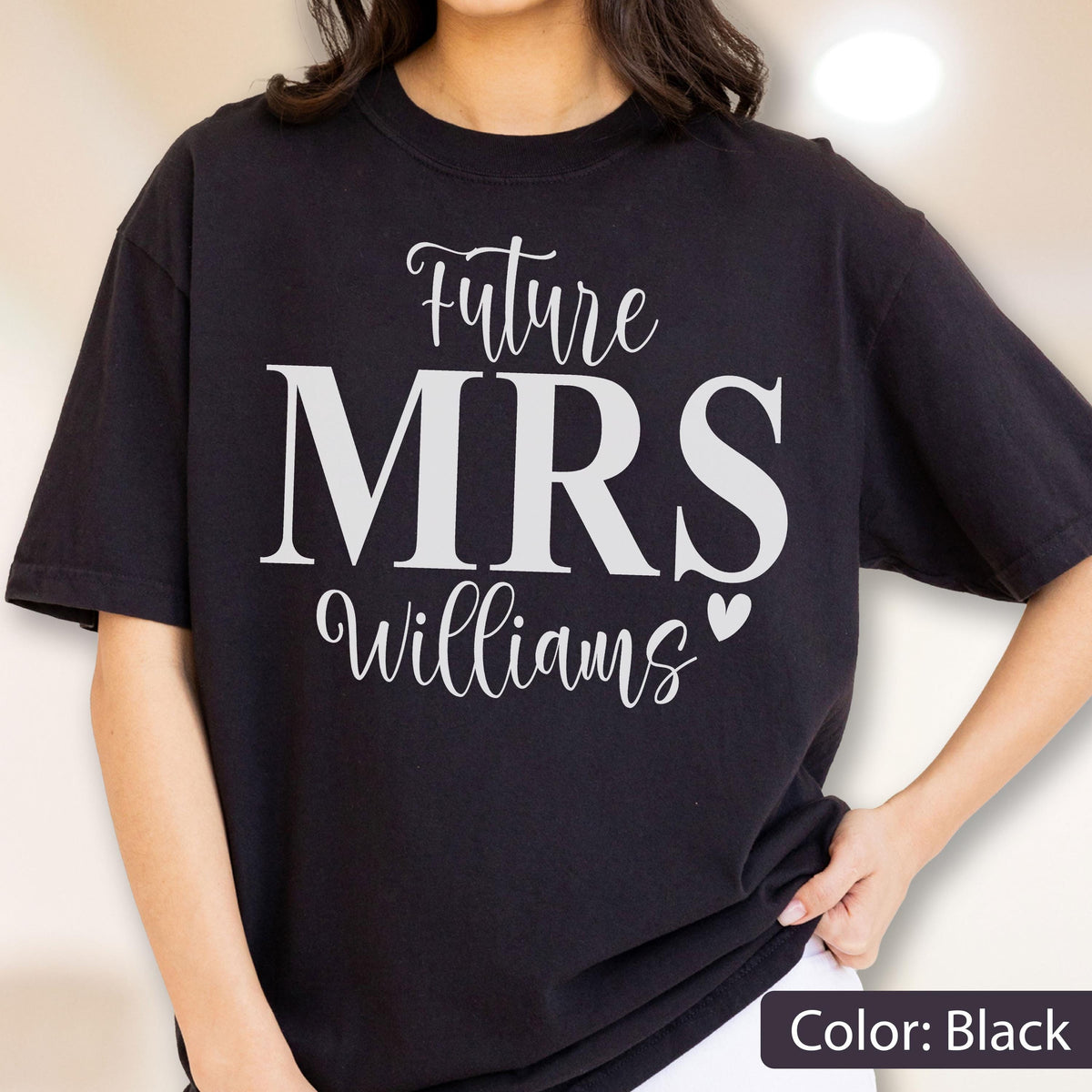 May include: A black short-sleeved t-shirt featuring white text that reads Future MRS Williams with a small heart icon. The word Future is in a script font, MRS is in a large bold serif font, and Williams is in a script font.