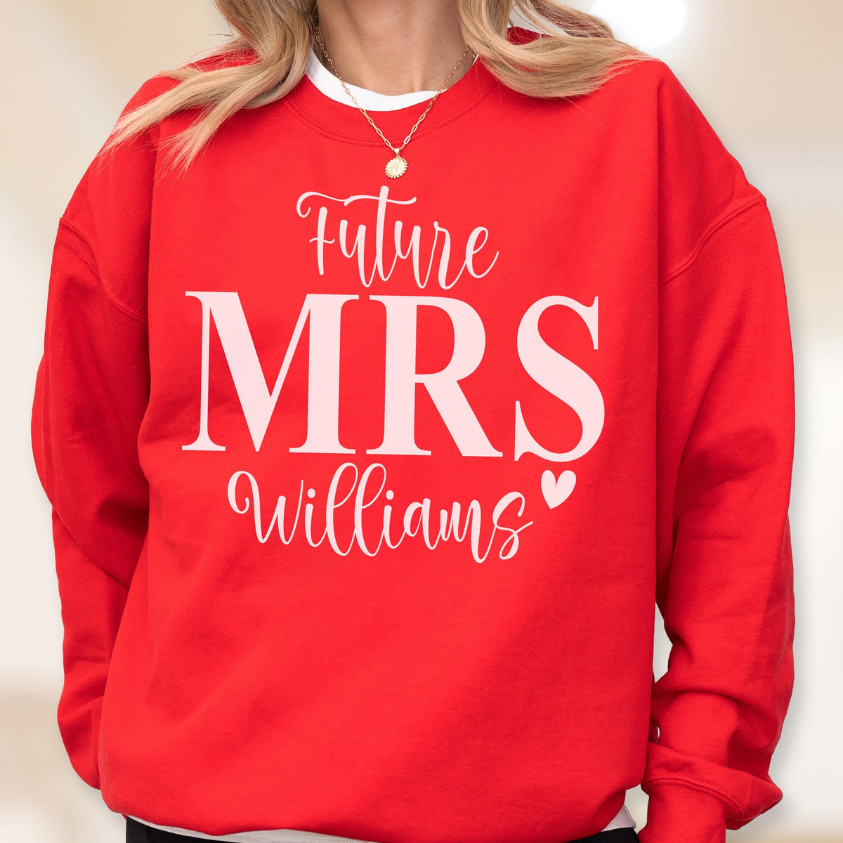 May include: A bright red crewneck sweatshirt featuring the white text Future MRS Williams with a small heart icon. The word Future is in a cursive script, MRS is in a large bold serif font, and Williams is in a cursive script below the text.