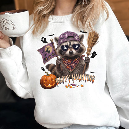 May include: A white crewneck sweatshirt featuring a graphic of a raccoon wearing a purple baseball cap, heart-shaped sunglasses with ghost reflections, and a patterned bandana. The raccoon holds a broom and a flag with a witch silhouette.