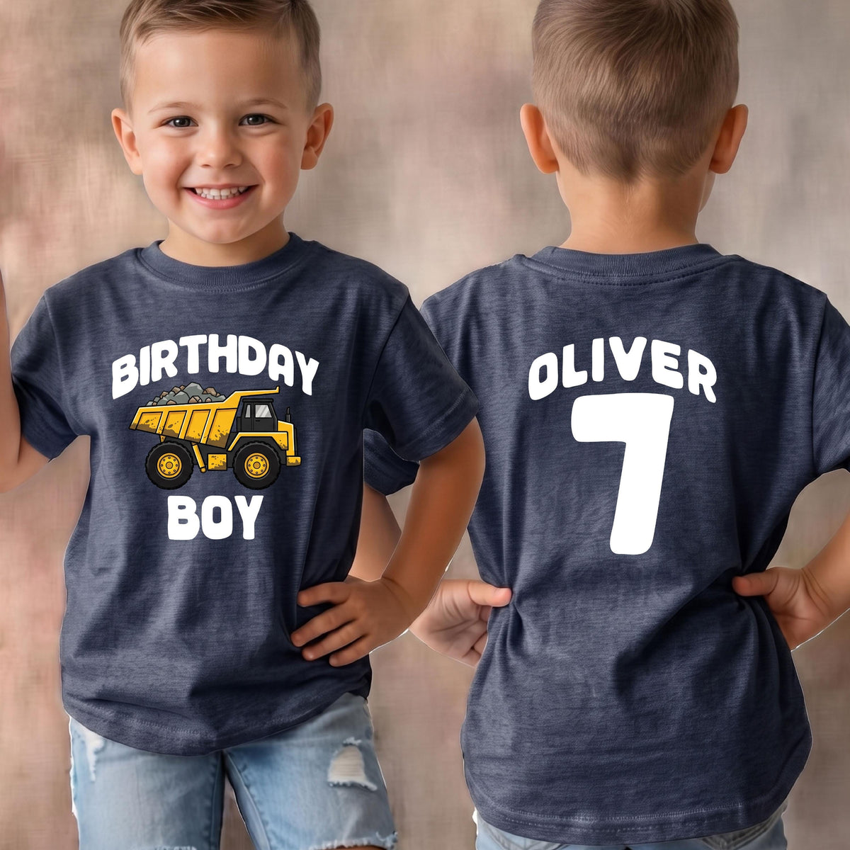 May include: A dark heather blue t-shirt featuring a yellow dump truck graphic with the white text "BIRTHDAY BOY" on the front and the white text "OLIVER" above the number "7" on the back, showcasing both the front and back views of the garment.