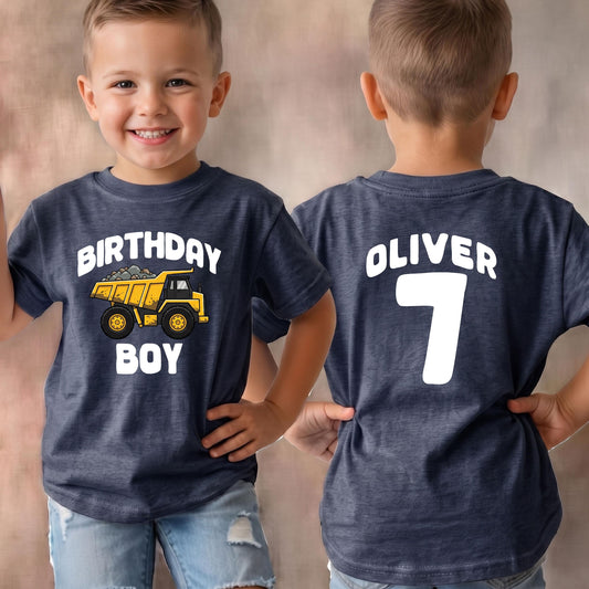 May include: A dark heather blue t-shirt featuring a yellow dump truck graphic with the white text "BIRTHDAY BOY" on the front and the white text "OLIVER" above the number "7" on the back, showcasing both the front and back views of the garment.