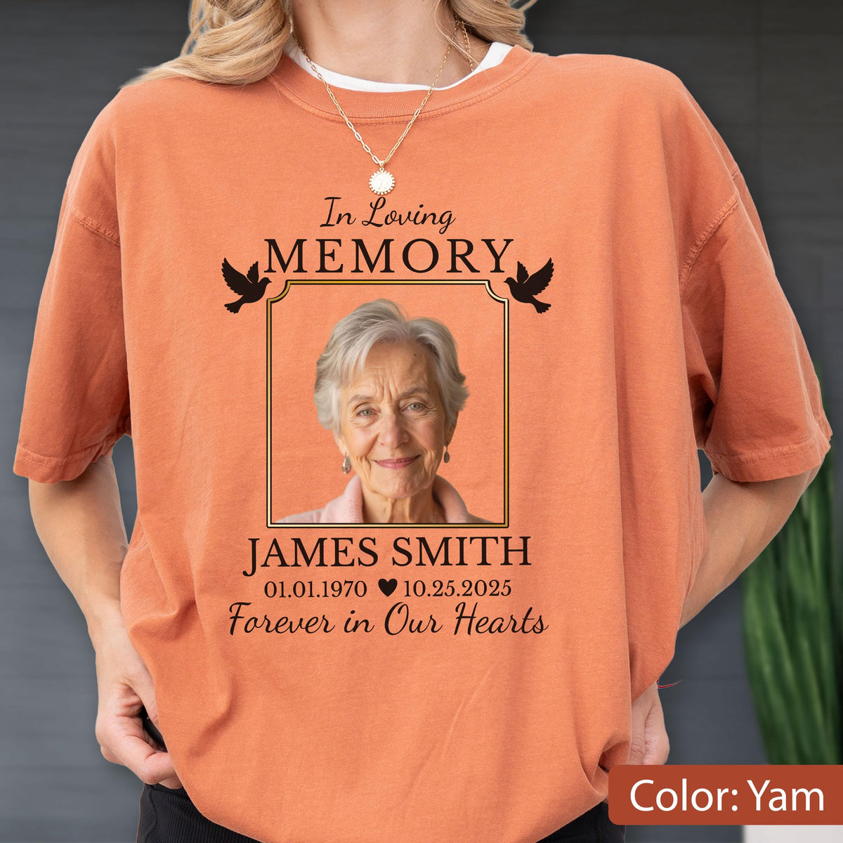May include: A burnt orange short-sleeve t-shirt featuring a memorial graphic with the text In Loving Memory, James Smith, 01.01.1970 - 10.25.2025, and Forever in Our Hearts, surrounding a portrait of an older person with two black bird silhouettes.