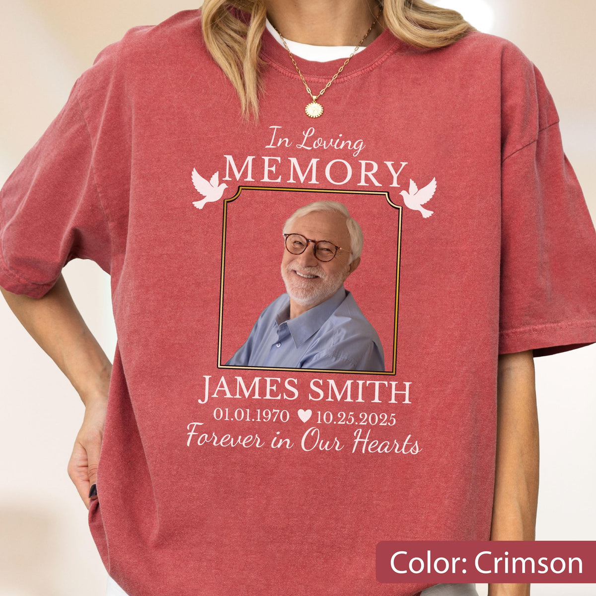 May include: A crimson short-sleeve t-shirt featuring a memorial graphic with a photograph of an older person wearing glasses. The text reads In Loving Memory, JAMES SMITH, 01.01.1970, 10.25.2025, and Forever in Our Hearts, with two white doves.